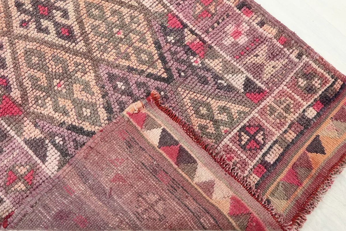 View of the back of the hand-knotted rug, revealing the cotton foundation