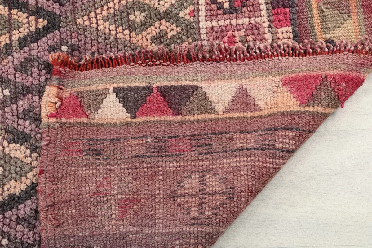 Close-up of the rug's fringe and the reverse side, showing craftsmanship