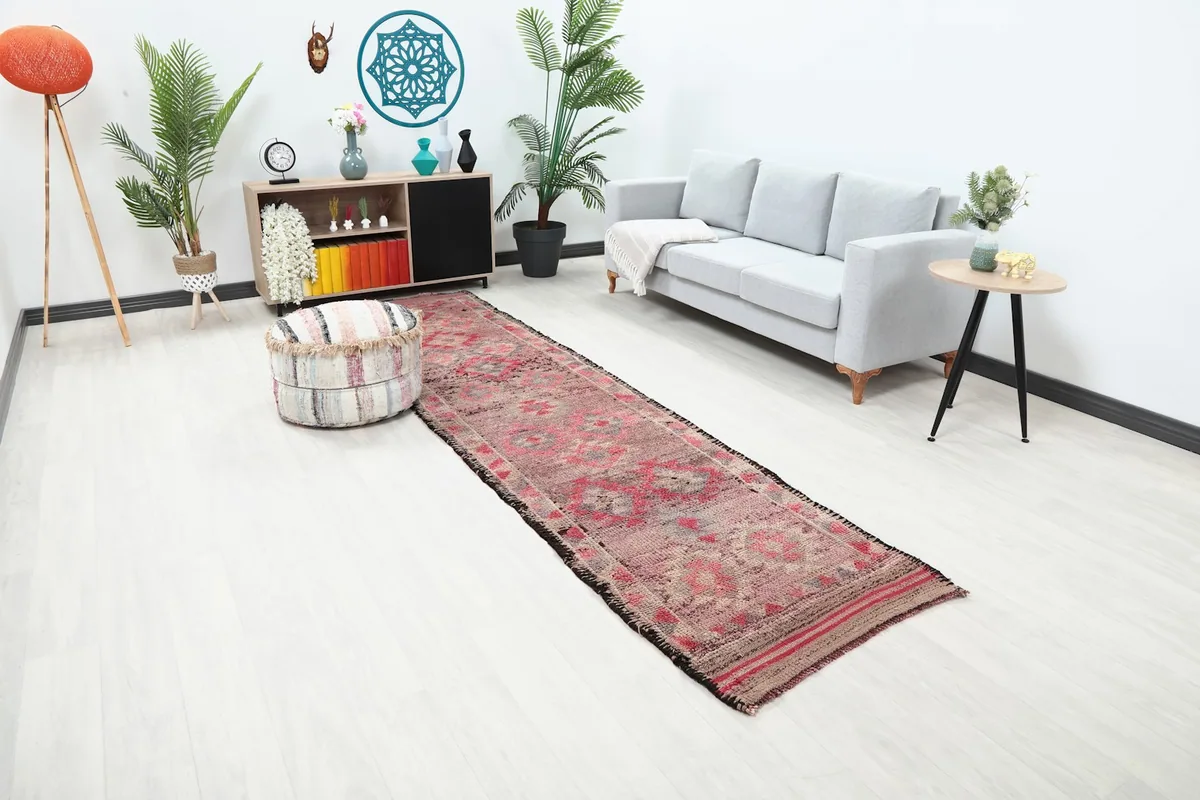 Overhead angle view of the Anatolian runner rug in a room, highlighting its geometric patterns and distressed charm.