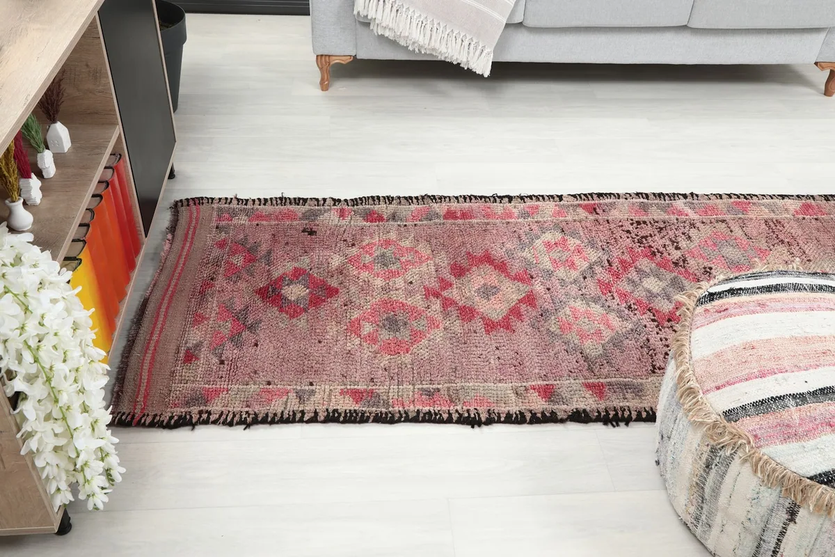 Long view of the runner rug extending down a hallway-like space, showcasing its functional size.