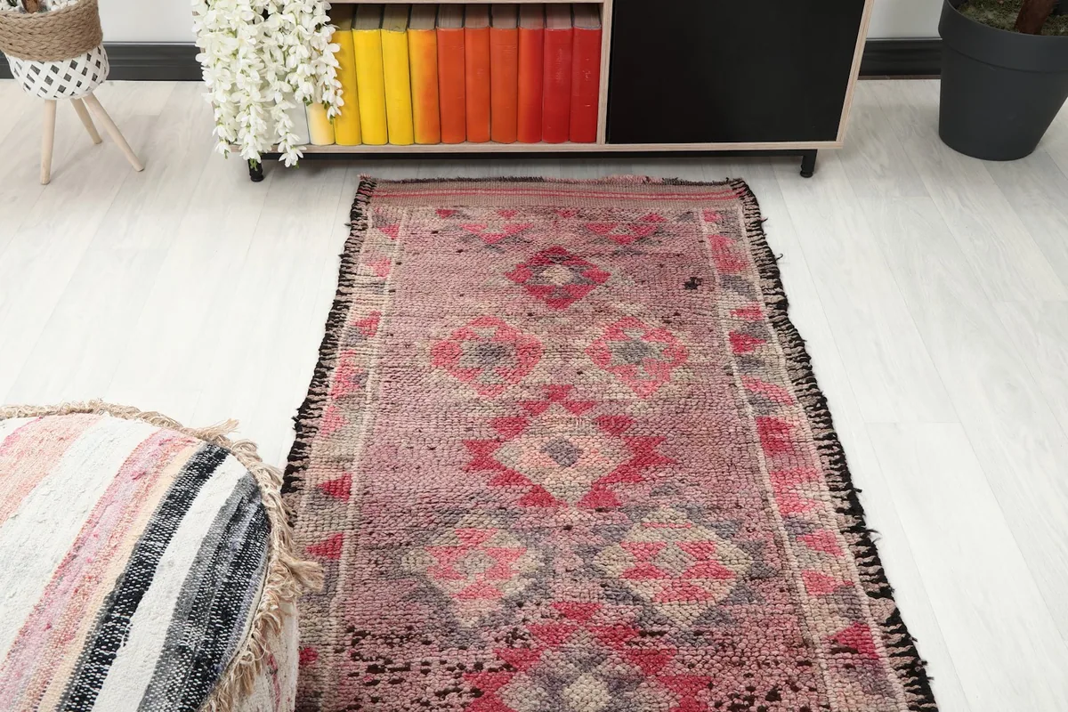 Overhead view of a section of the runner rug, showing its patterns and overall condition in the room.