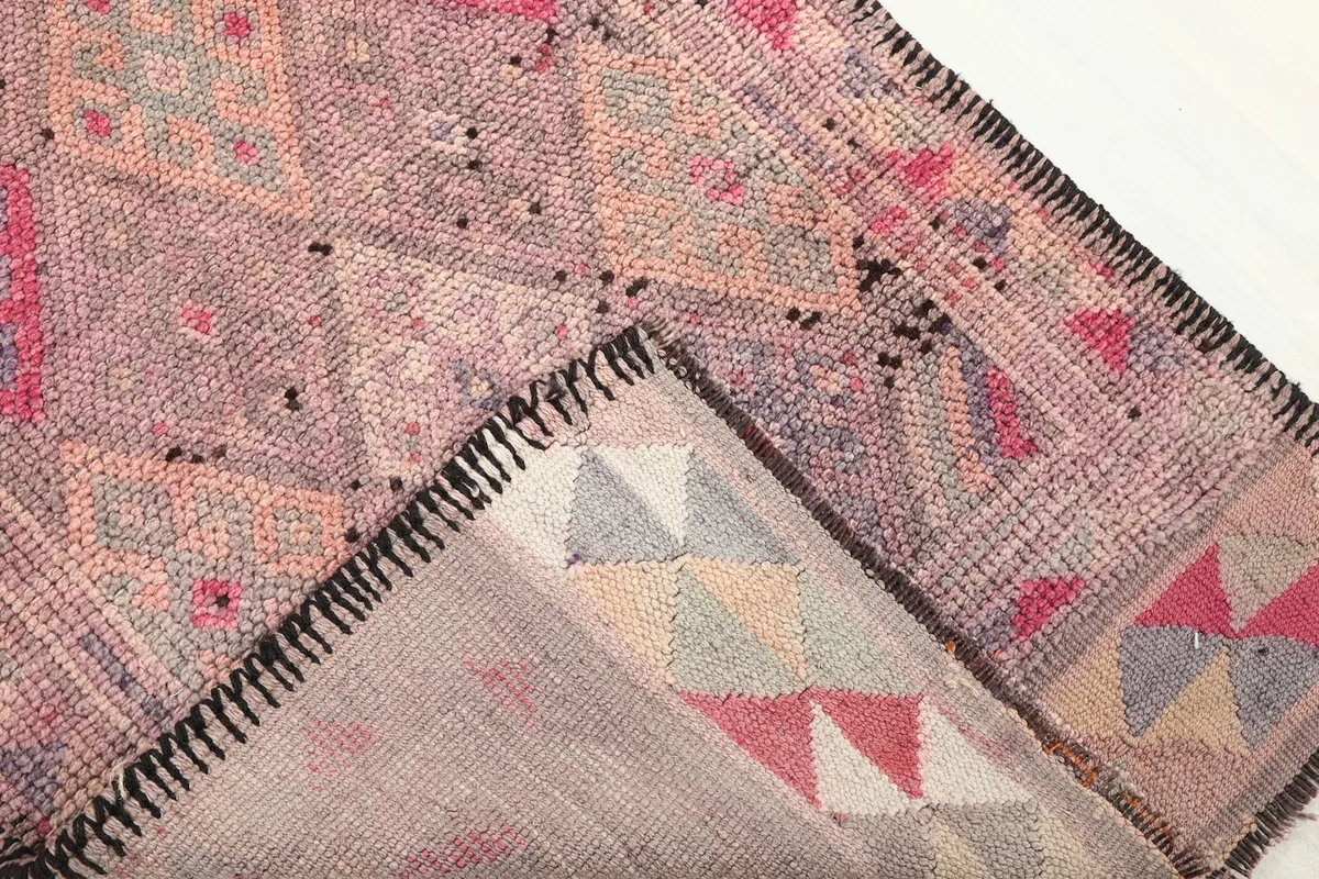 View of the back of the rug revealing the cotton foundation and knotting