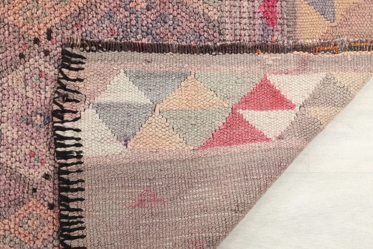 Close-up of the reverse side of the rug showing hand-knotted details and fringe