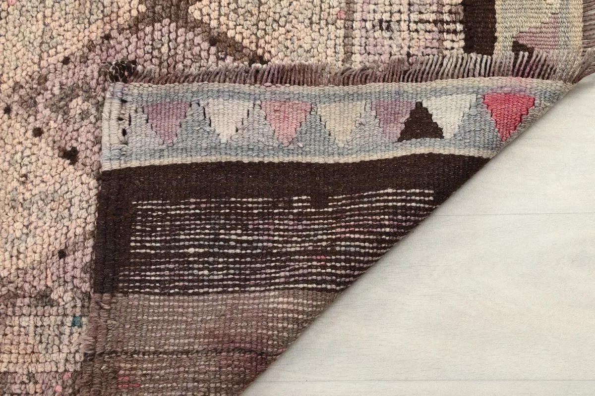 View of the back of the hand-knotted rug, showing the cotton foundation and the knotting detail.