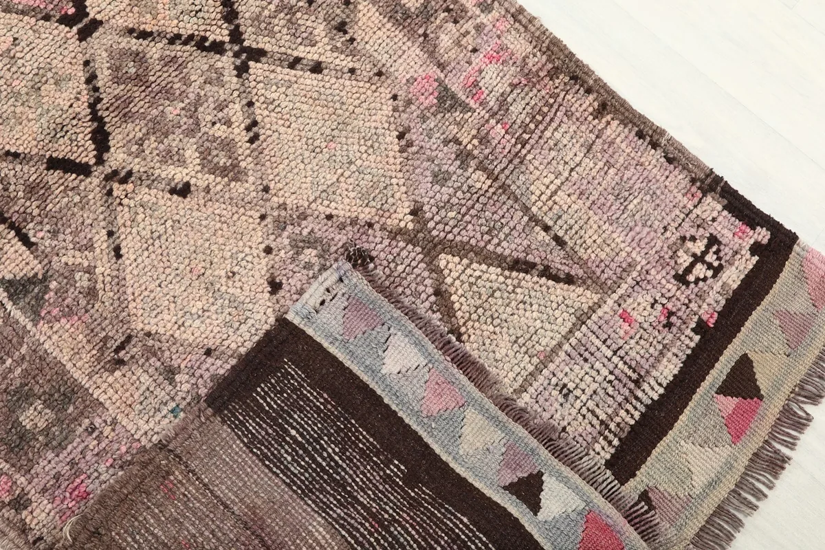 Folded section of the runner rug, revealing the thickness of the wool pile and the construction.