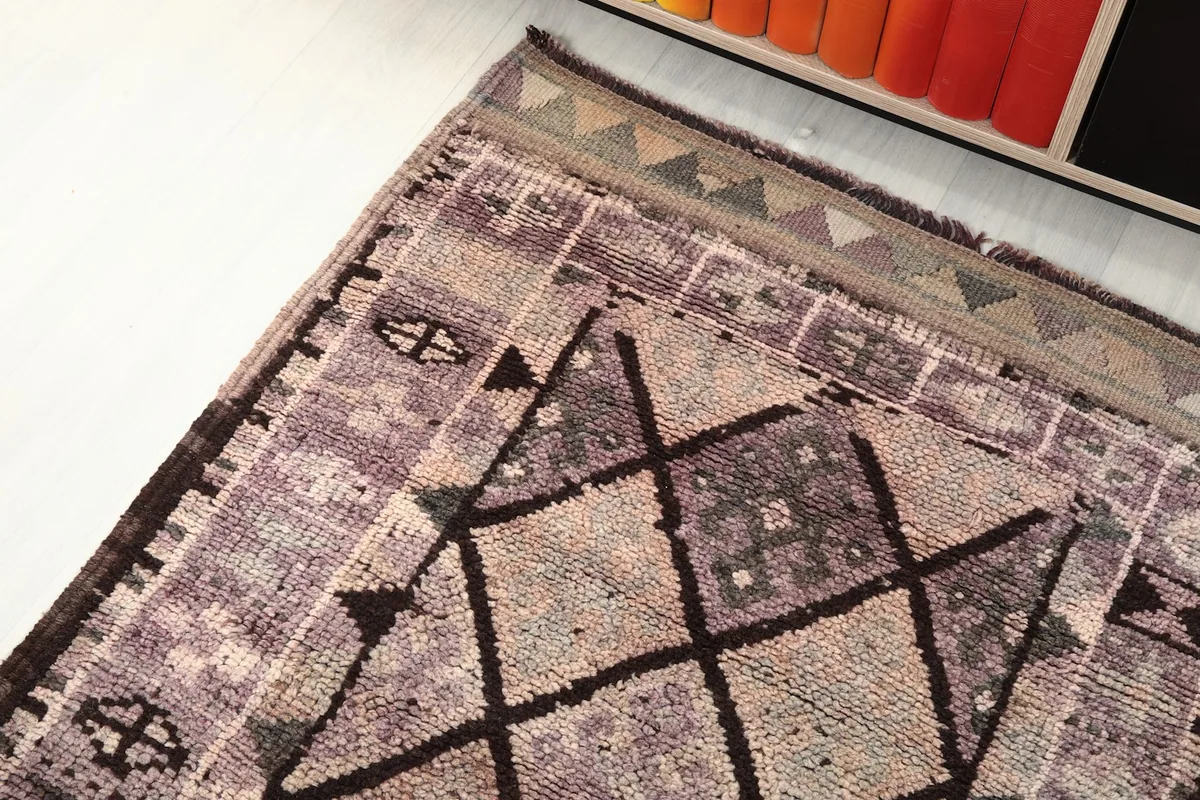 Overhead view focusing on a section of the runner rug, revealing its tribal motifs and color palette.