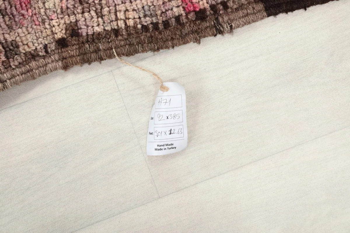 Close-up of the rug's product tag, indicating its hand-made origin from Turkey.
