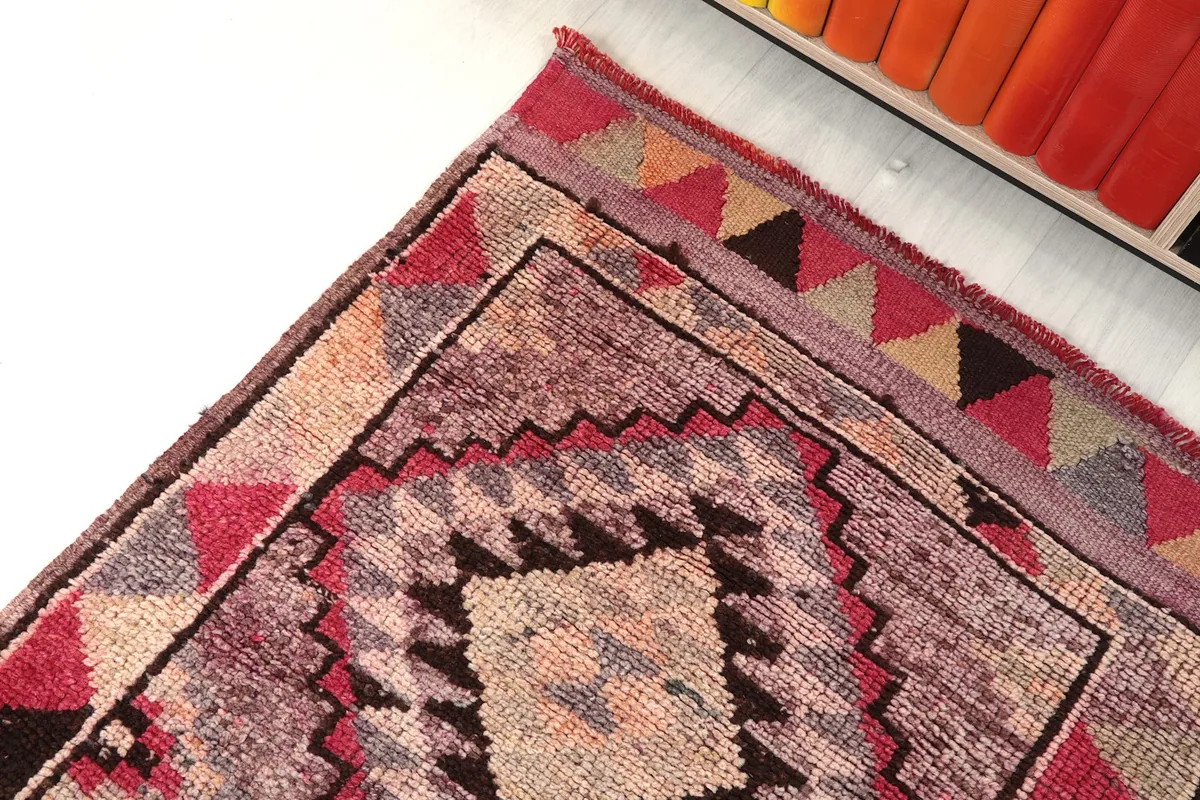 Corner detail of the runner rug, showing the intricate geometric design and border colors