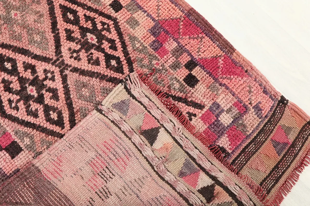 View of the back of the rug, revealing the cotton foundation and hand-knotted construction.
