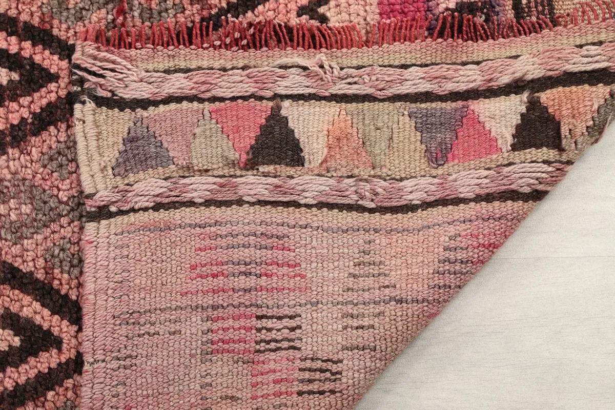 Close-up of the fringe and edge finish, showcasing the craftsmanship and vintage condition.