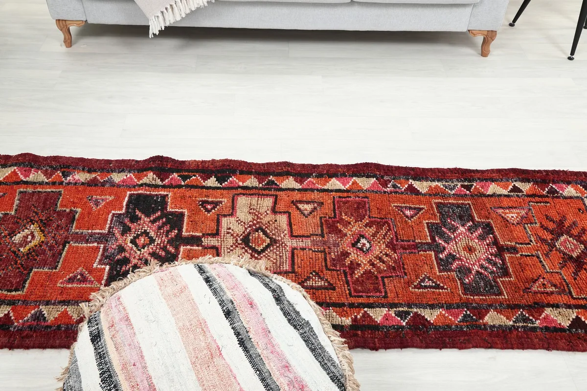 Overhead perspective of the runner rug in a room setting, showing its length and motifs
