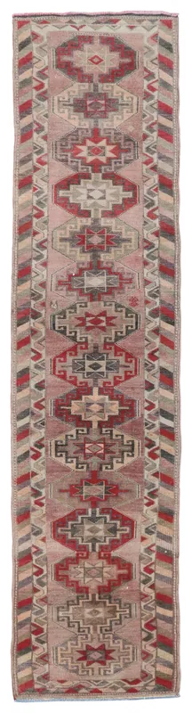 Full top view of the 2'7" x 12'4" rose geometric Anatolian runner rug on a white background