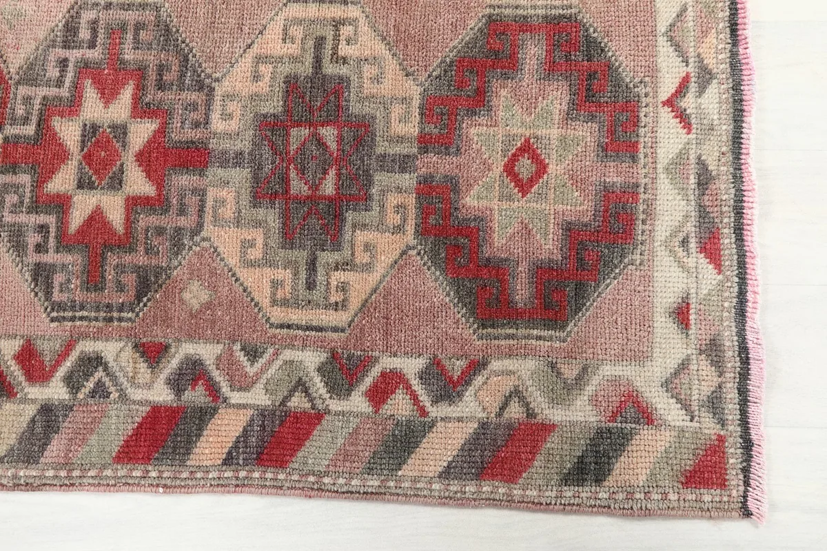 Detailed view of the repeating geometric medallions and border patterns on the Anatolian runner