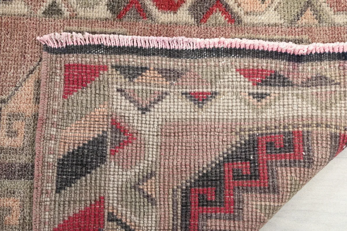 Close-up of the back of the rug, showing the dense hand-knotting and the fringe detail