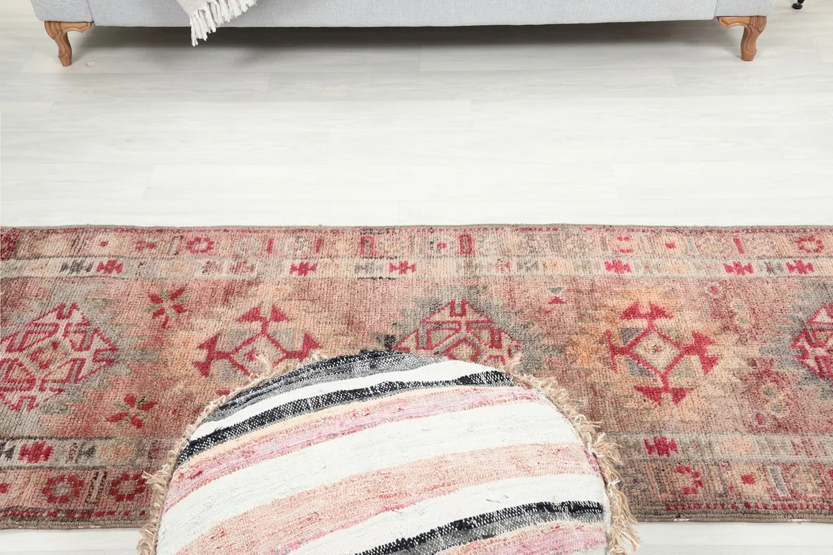 Angled view looking down the length of the runner rug, emphasizing its elongated shape and patterns.