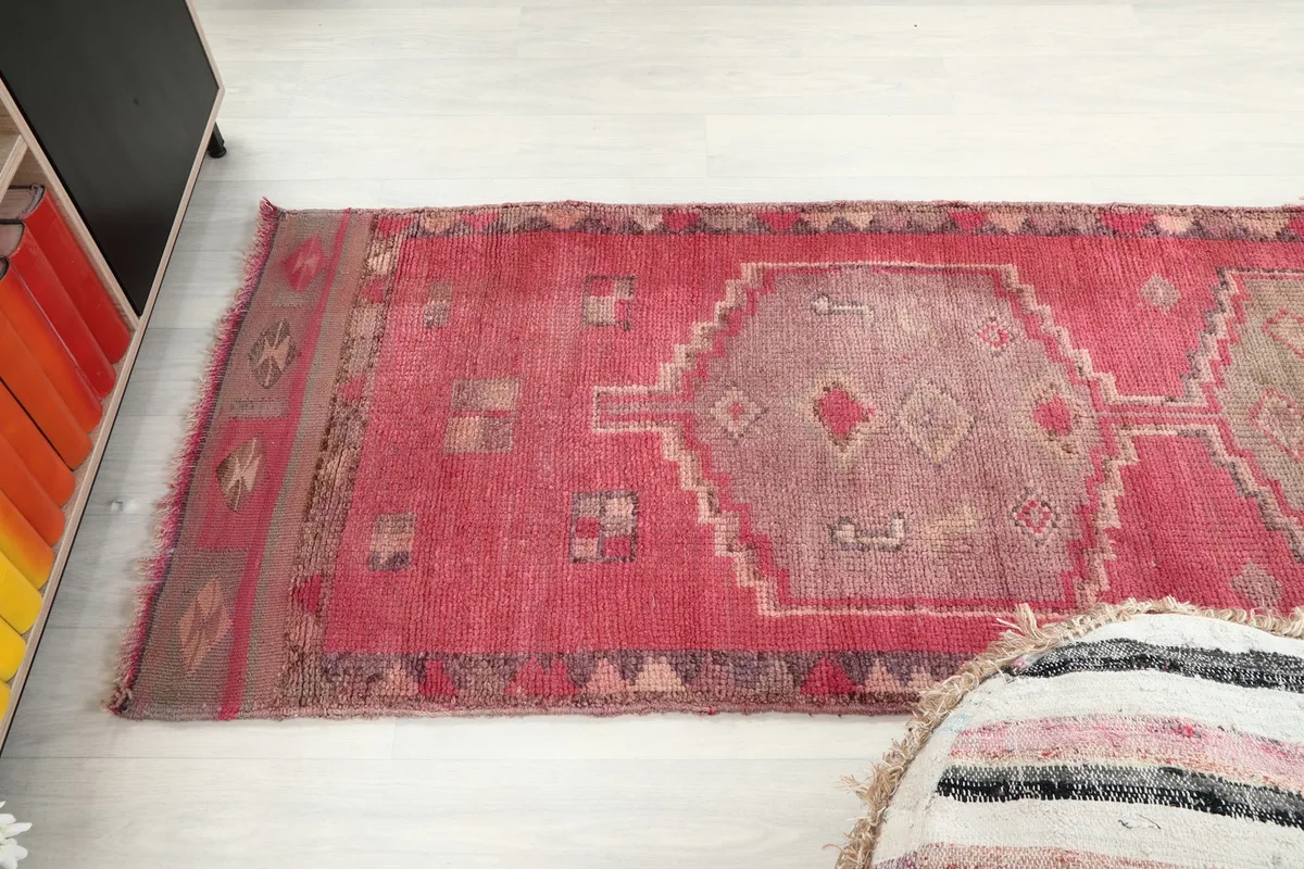 Angled view of the runner rug extending across a light-colored floor, showcasing its length.