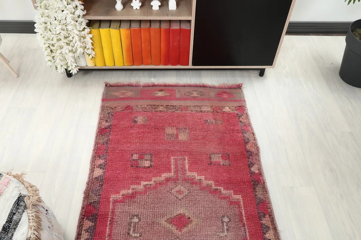 Overhead view of a section of the rose runner rug in a room setting, showing its placement.