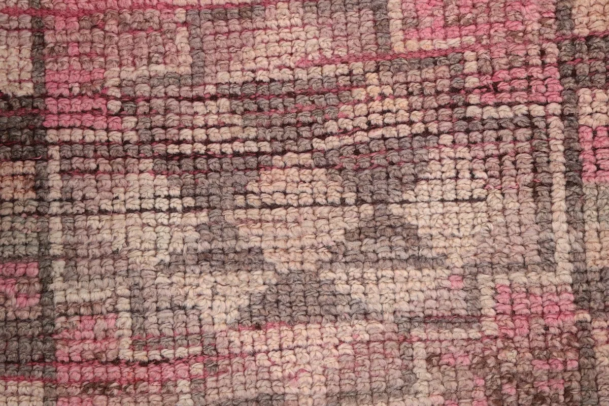 Extreme close-up of the low wool pile, revealing the intricate knotting and color blend