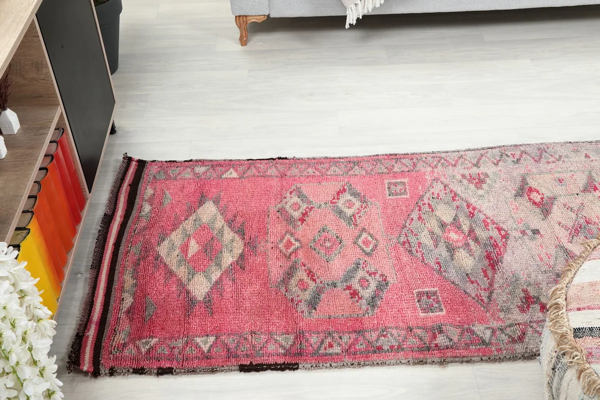 Angled view of the runner rug in a room, showing its full length and design