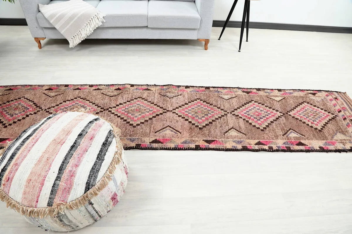 Long view of the runner rug in a room, emphasizing its scale next to furniture