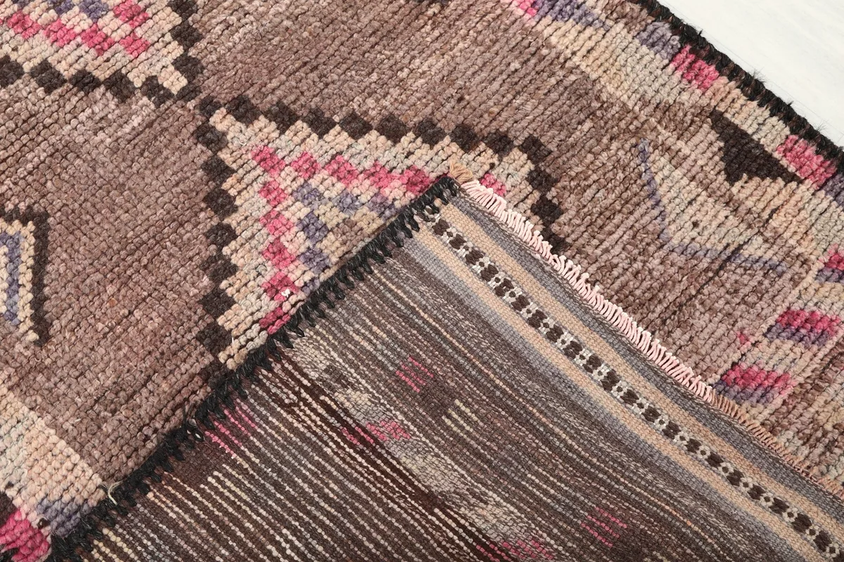 View of the back of the hand-knotted wool runner rug, showing the cotton foundation