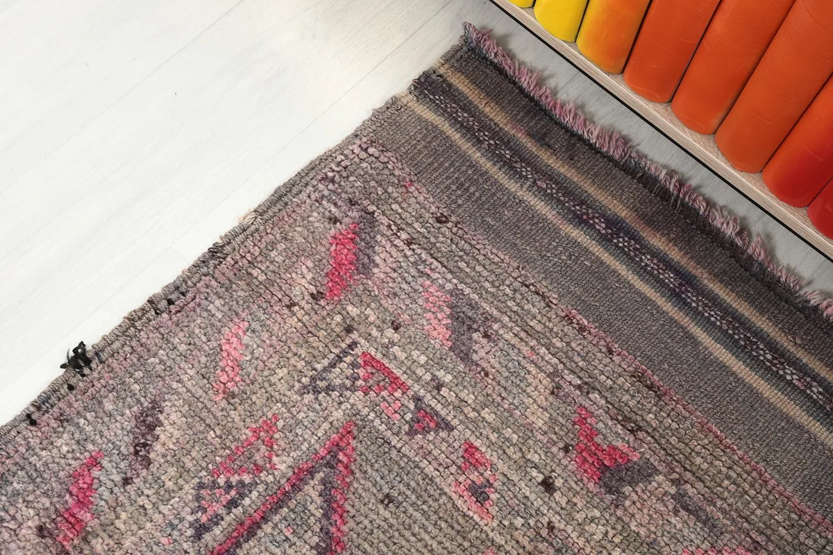 Corner detail of the runner rug, focusing on the subtle border and fringe