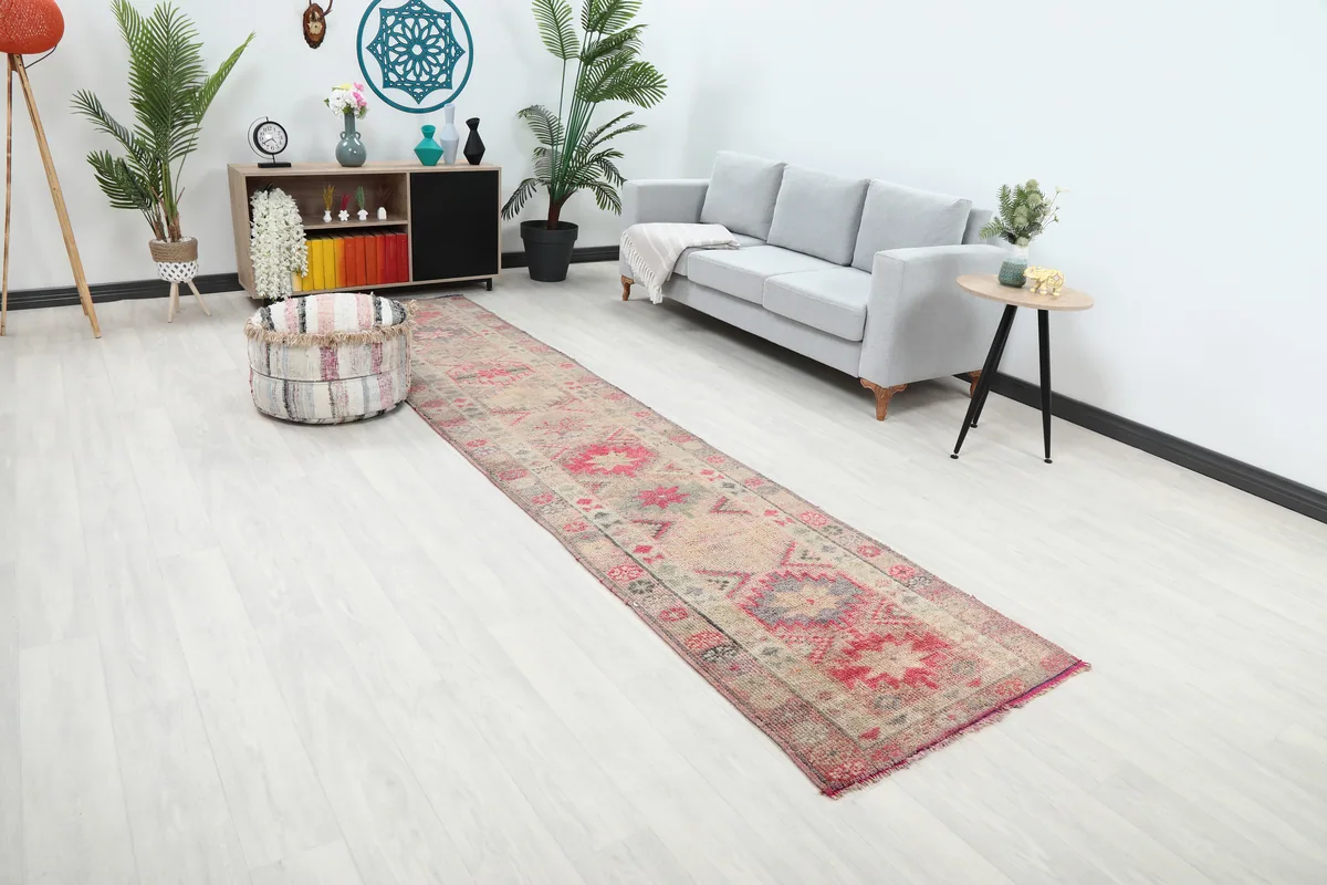 Soft Rose Geometric Anatolian Runner from an elevated angle, showing its placement in a bright room.