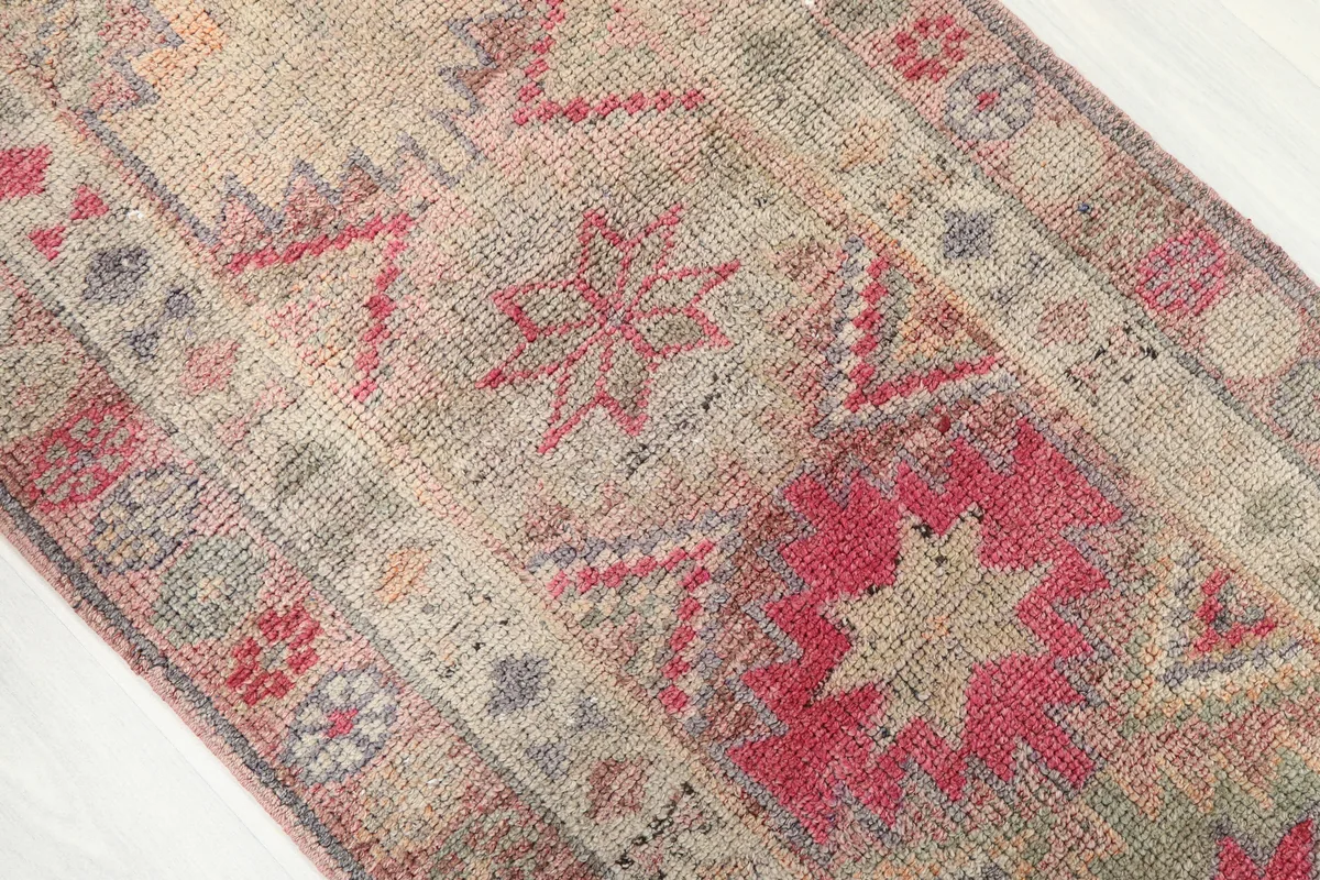 Close-up of the Soft Rose Geometric Anatolian Runner's surface, revealing the hand-knotted wool pile.