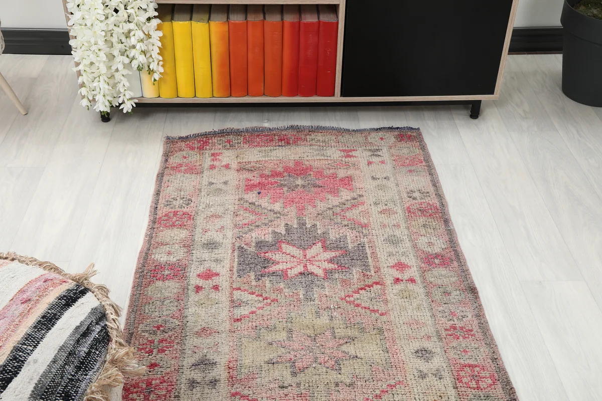 Soft Rose Geometric Anatolian Runner viewed from above in a room setting, showing its length and pattern.