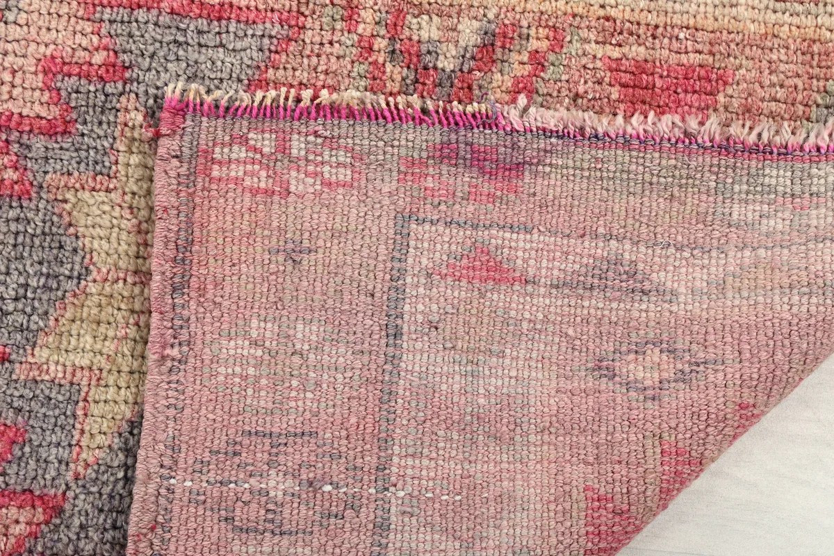 Detail of the reverse side and edge of the Soft Rose Geometric Anatolian Runner, showing its construction.