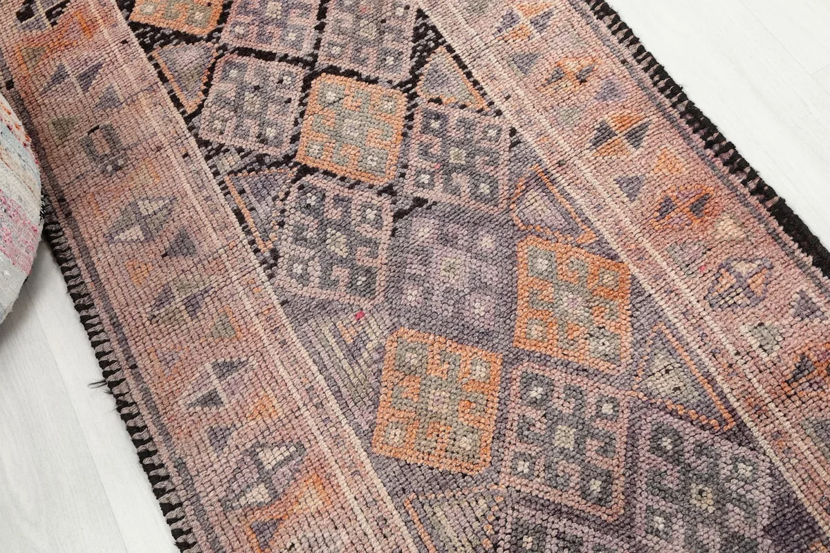 Overhead view focusing on the central geometric motifs in shades of orange, gray, and black.