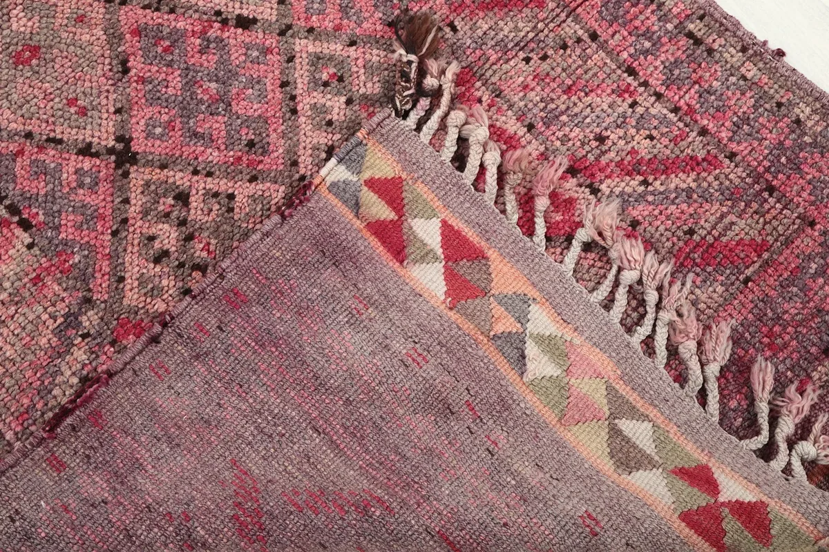 View of the back of the rug, revealing the cotton foundation and hand-knotted construction