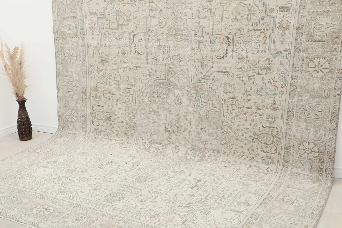 Angled view of the oversized Persian rug showing its full length and design against a wall.