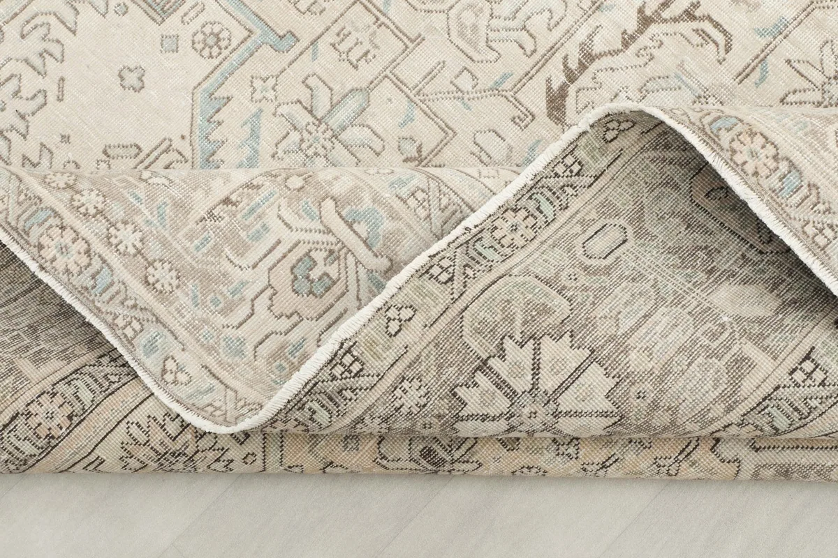 Underside view of the hand-knotted rug, revealing the cotton foundation and knot structure.