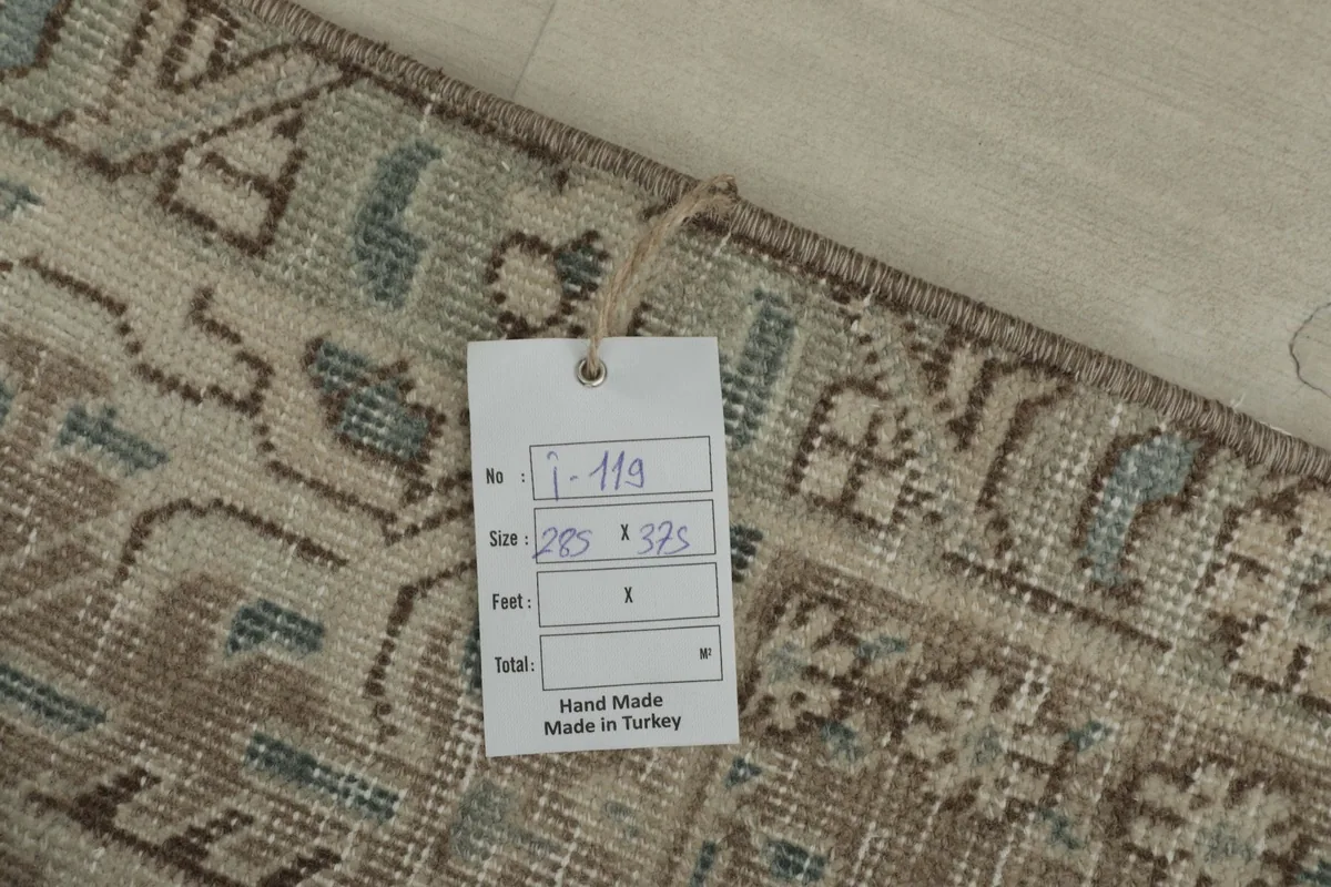 Close-up of a tag on the rug, indicating its size and handmade origin.