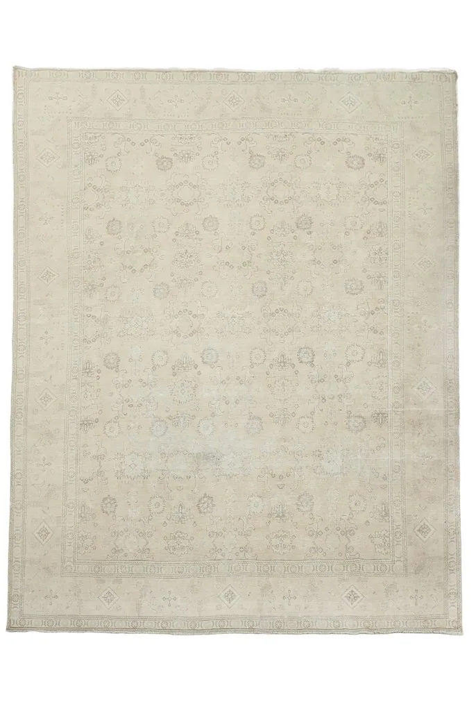 Full overhead view of the beige vintage Persian area rug with subtle gray patterns