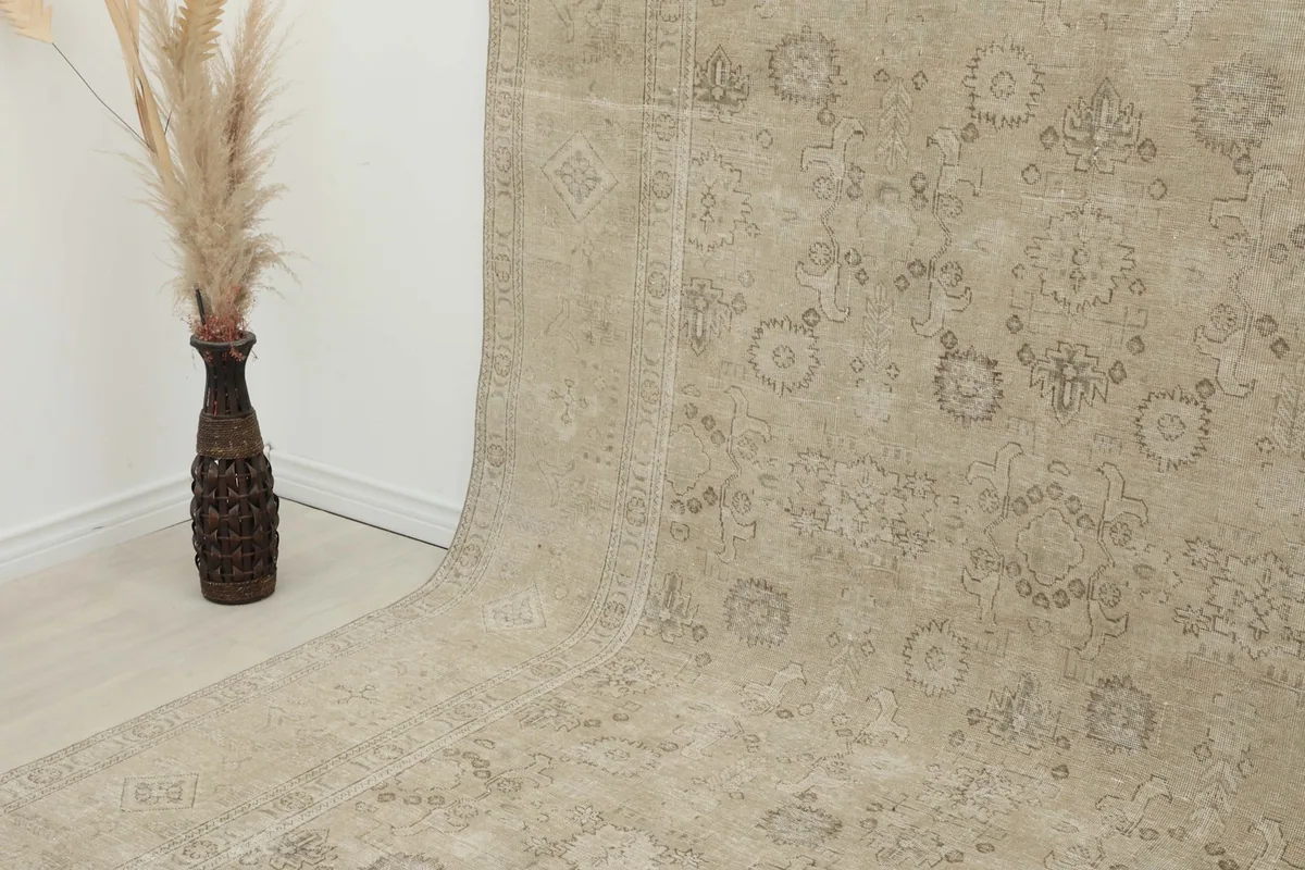 Close-up angled view of the rug's surface and patterns as it drapes from the wall