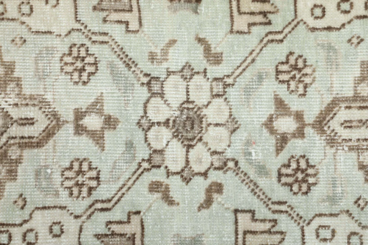 Close-up of the Cream Medallion Persian Rug's pattern, revealing the faded green and brown hues.