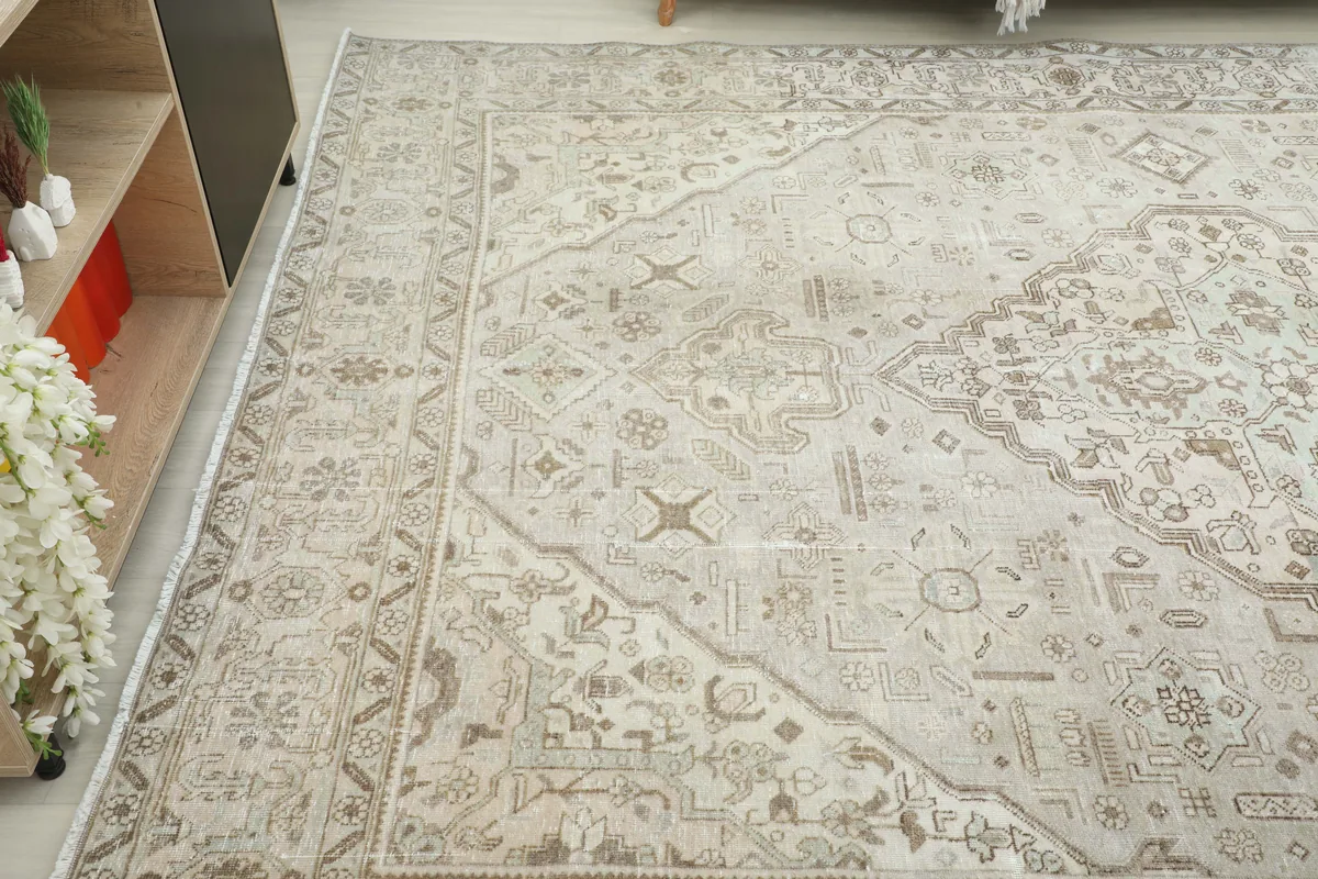 Another angled view of the Cream Medallion Persian Rug, emphasizing its large scale and gentle wear.