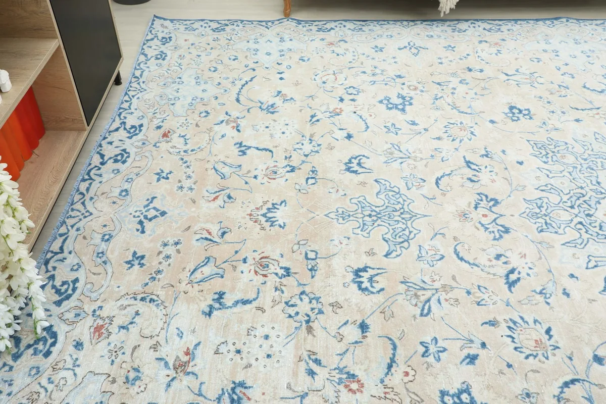 Angled view highlighting the overall pattern and subtle patina of the vintage rug.