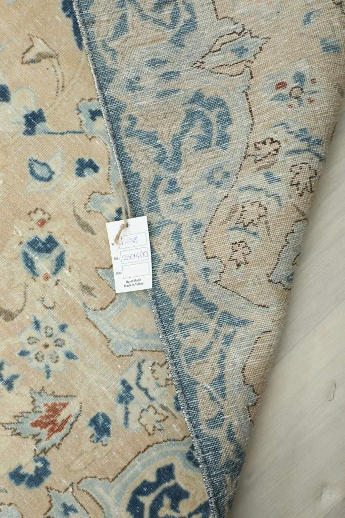 View of the back of the rug, showing the cotton foundation and hand-knotted structure.
