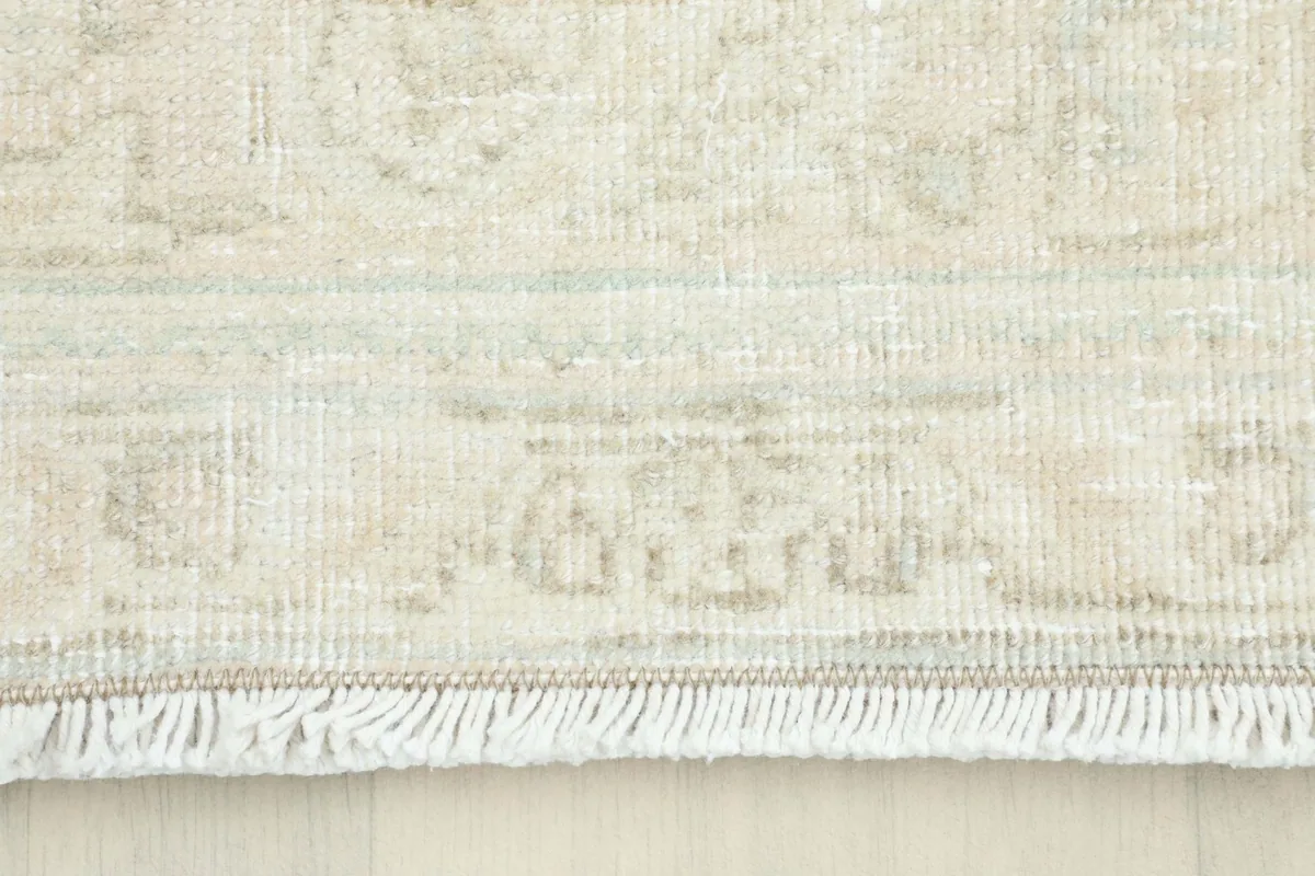 Close-up of the fringe and edge of the hand-knotted vintage rug