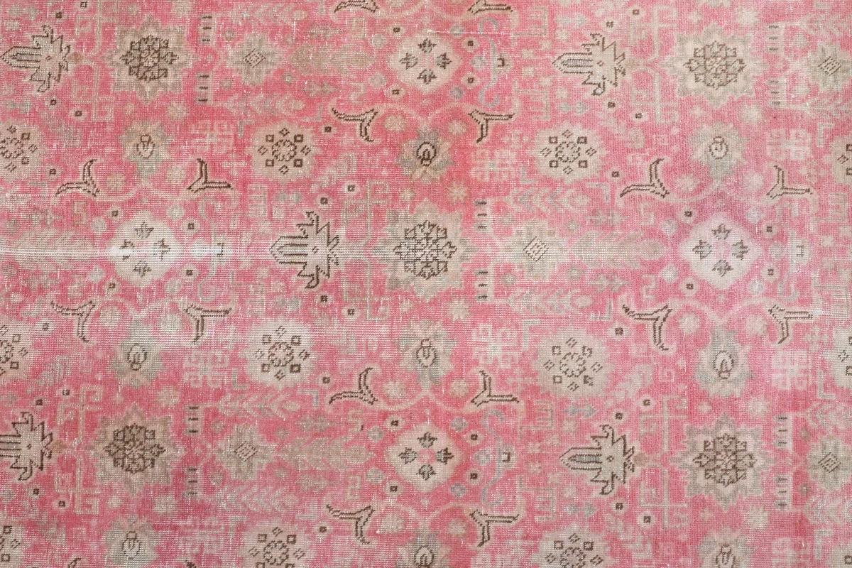 Close-up of the faded rose field, showing repeating geometric and floral motifs in beige and gray.