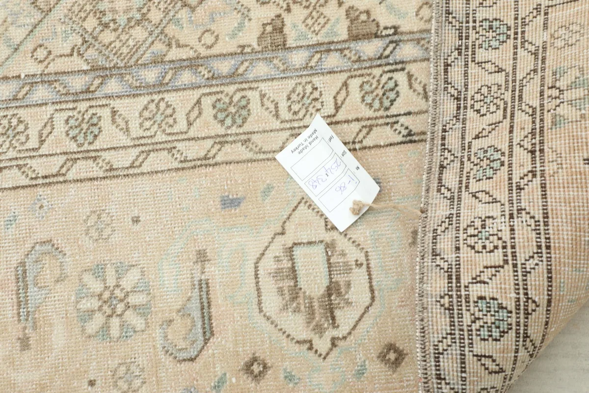 Close-up of the rug's backside, displaying the tight hand-knotted weave and cotton foundation.