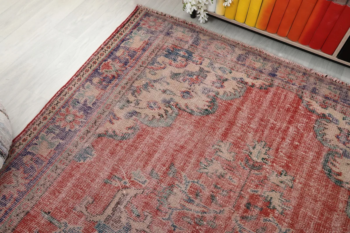 View of the rug's surface highlighting the faded red and purple tones