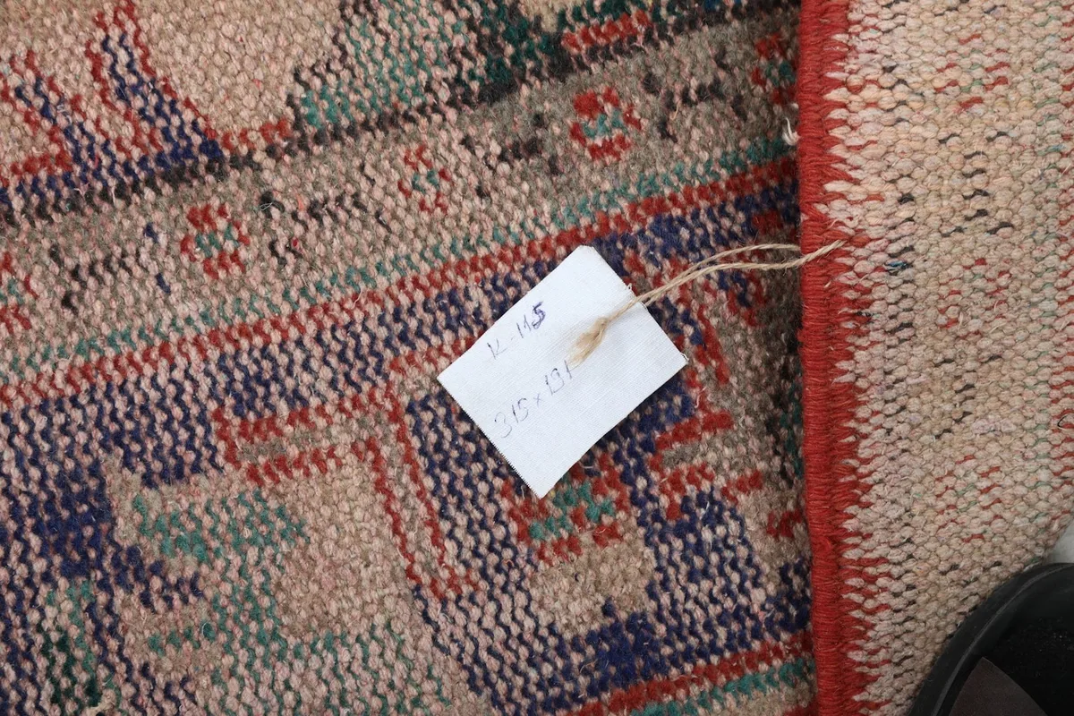 Tag showing the rug's dimensions and details attached to the back