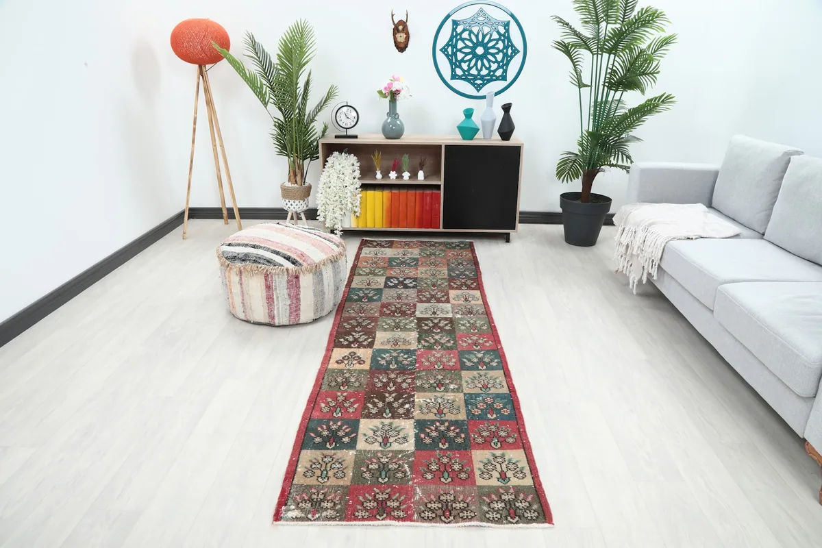 Vintage runner rug displayed in a modern living room setting with a light sofa