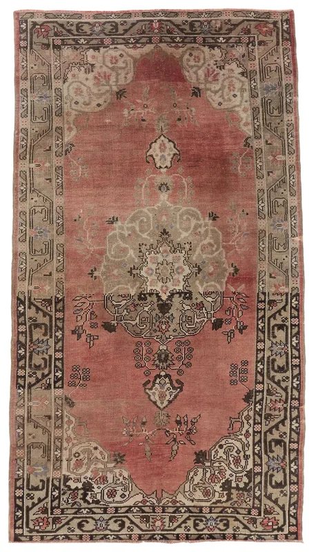 Full overhead view of the vintage rose and beige Anatolian area rug