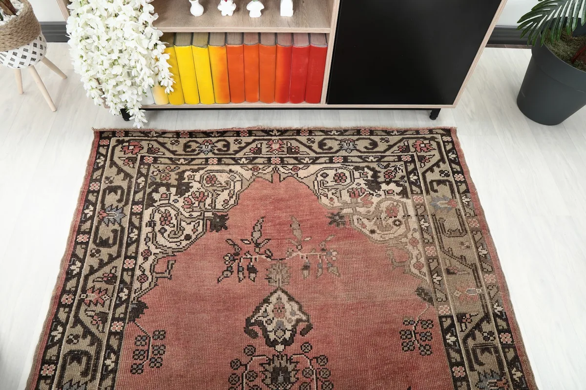 Overhead view focusing on the upper half of the rug with its medallion and border