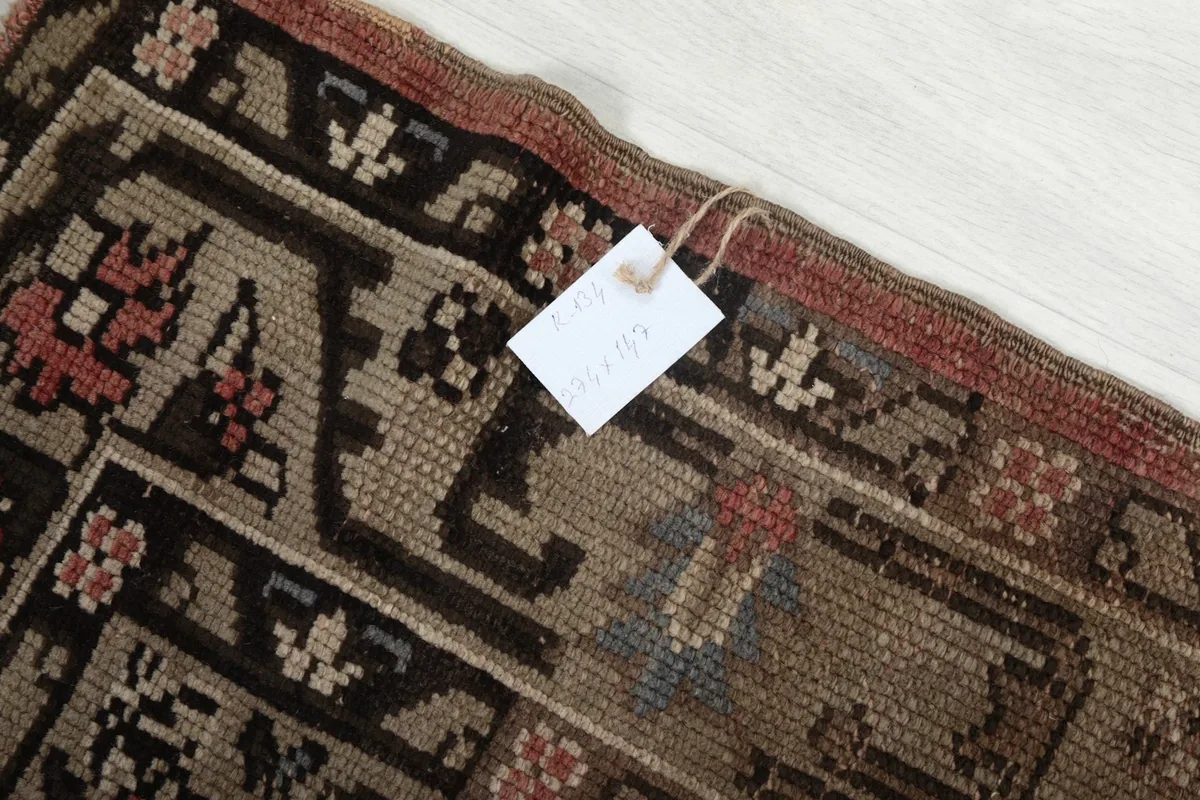 Detail of the rug's edge with a tag, showing the weave and minor fringe